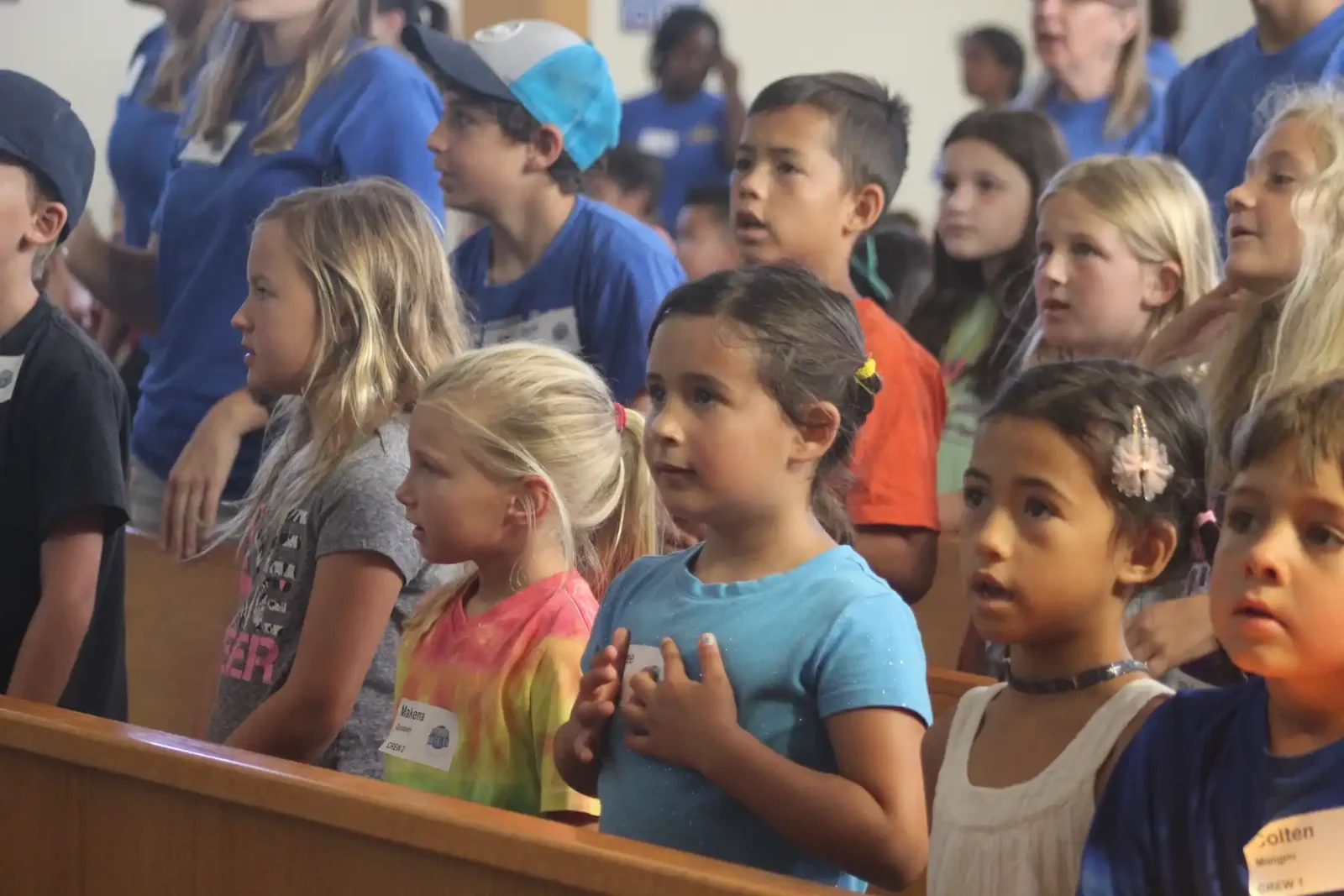 Reformation students singing together during chapel in the church sanctuary
