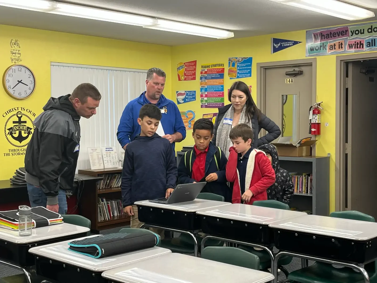 Parents and grandparents visiting a Reformation classroom and looking over students' work