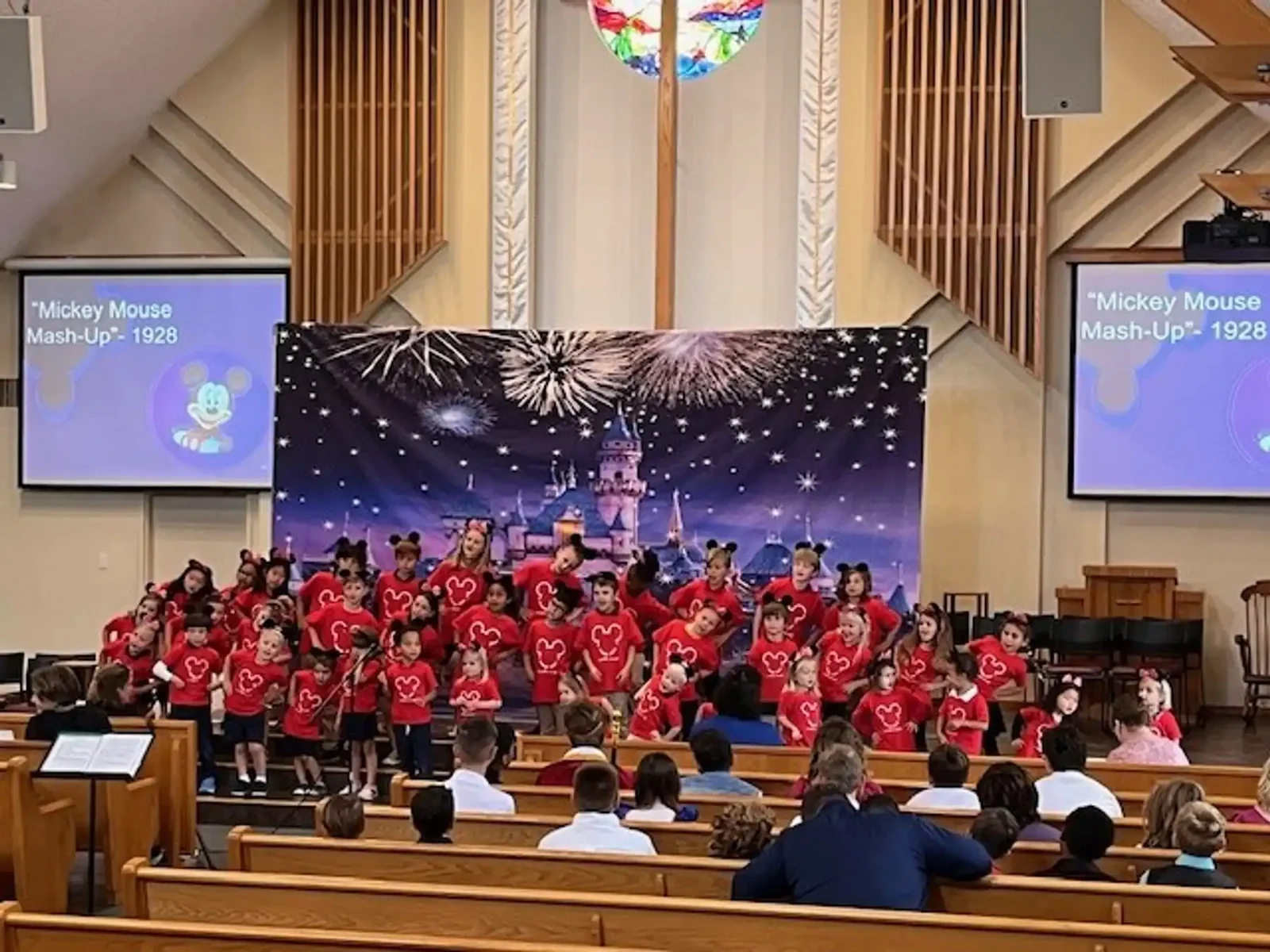 Reformation students in red shirts performing a concert in the church sanctuary