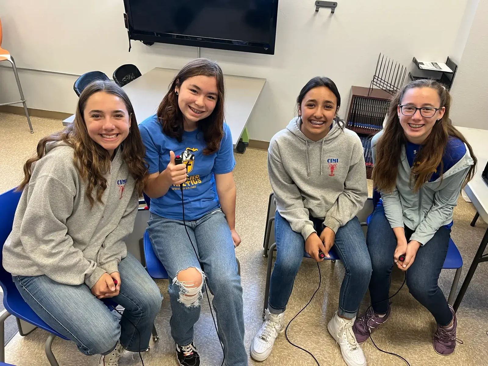 A group of Reformation middle school students sitting together and laughing