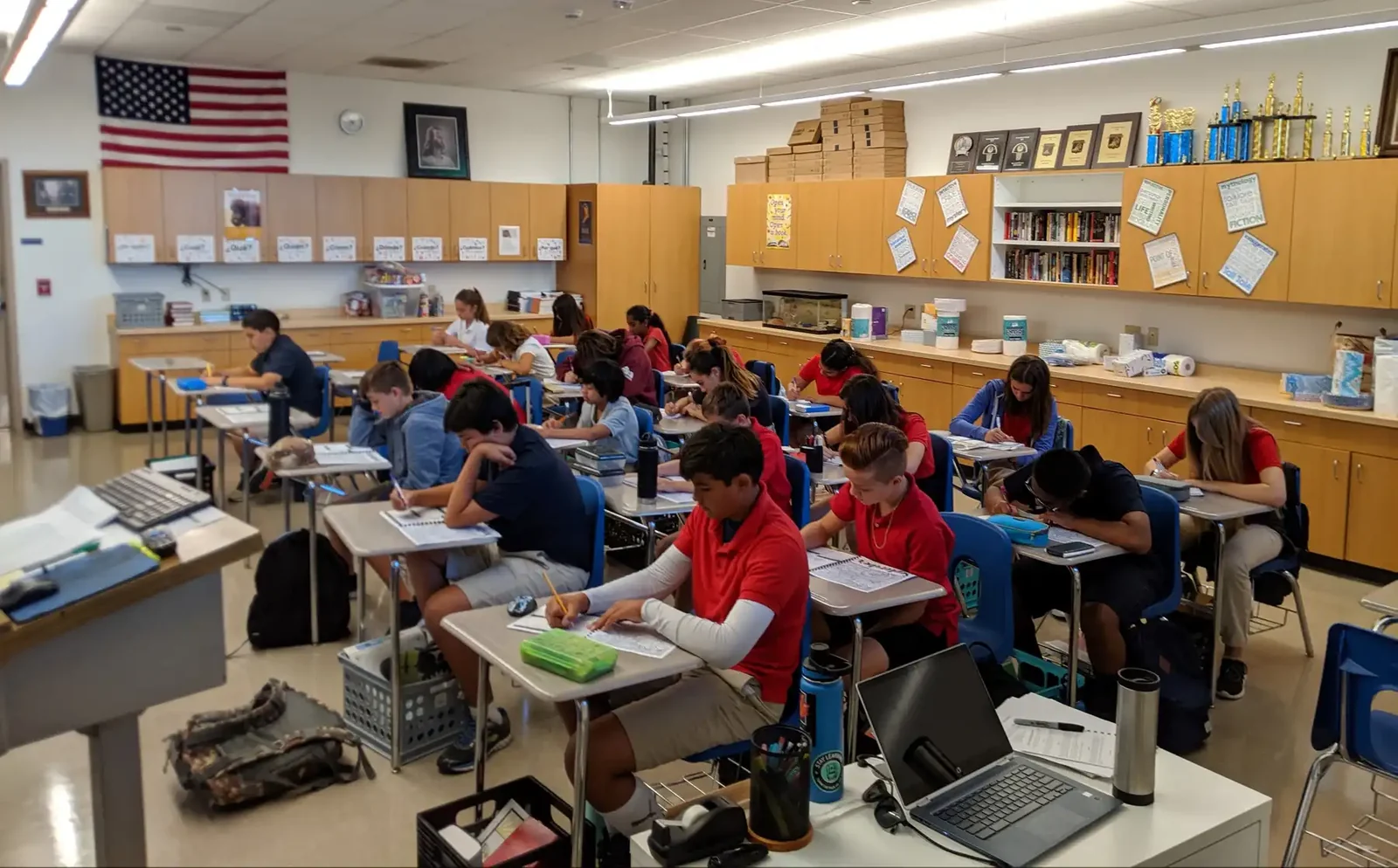 Sixth through eighth grade students working at their desks with Chromebooks in the Reformation middle school classroom