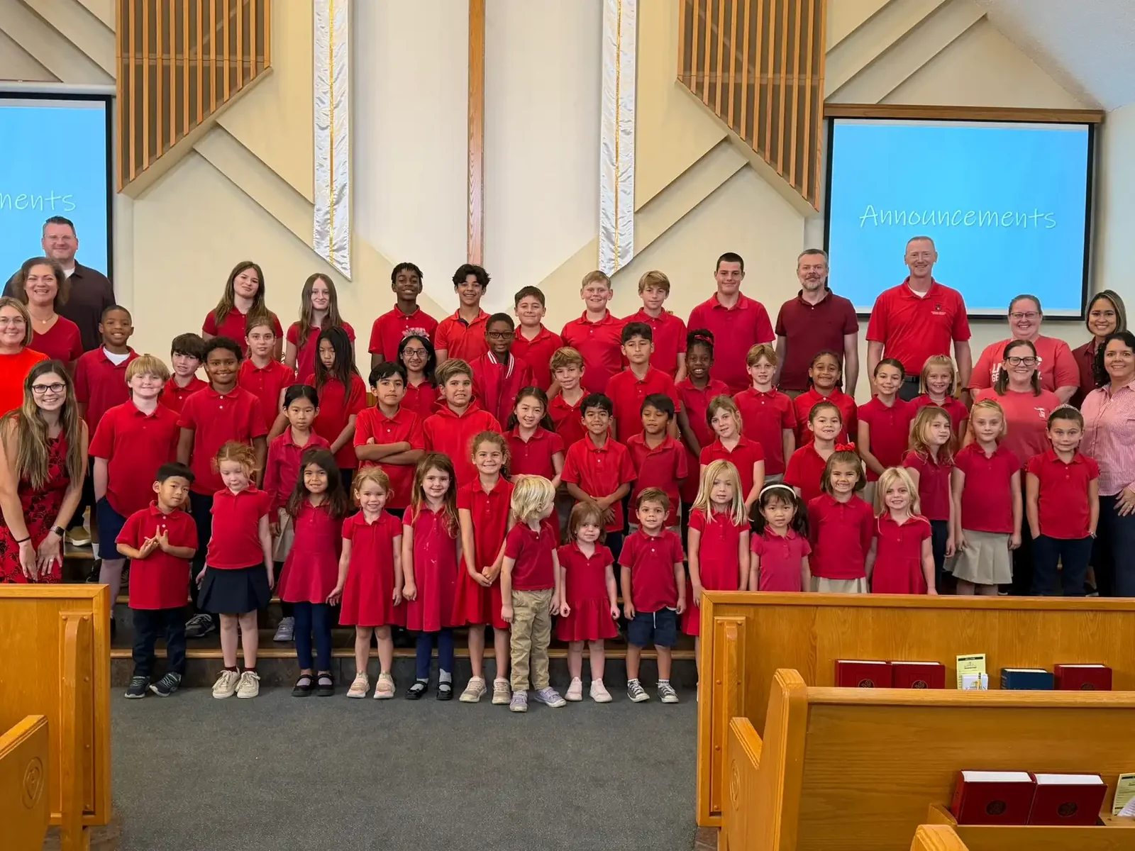 The whole student body of Reformation Lutheran School gathered in the church sanctuary in red school shirts