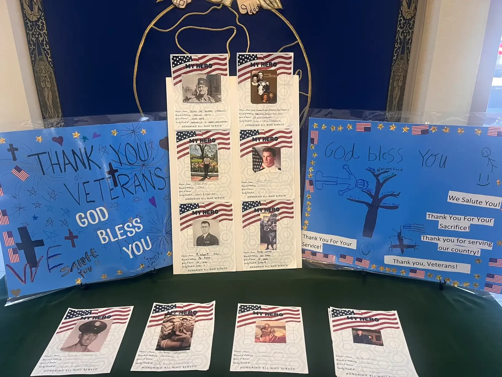 A student-made display thanking veterans with photos and flags